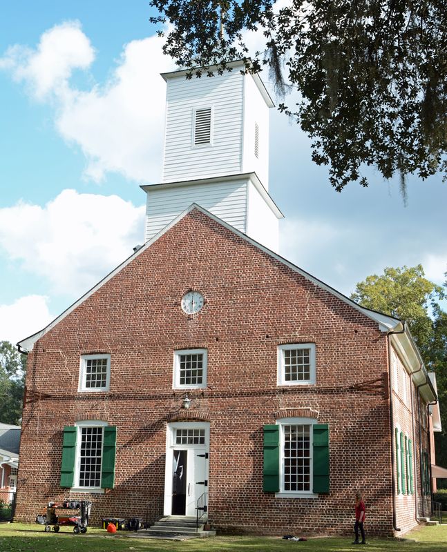 Front of Jerusalem Church at Ebenezer: red brick, green shutters, a white door and a white wooden steeple